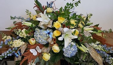 Yellow Blue and White casket spray