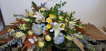 Yellow Blue and White casket spray